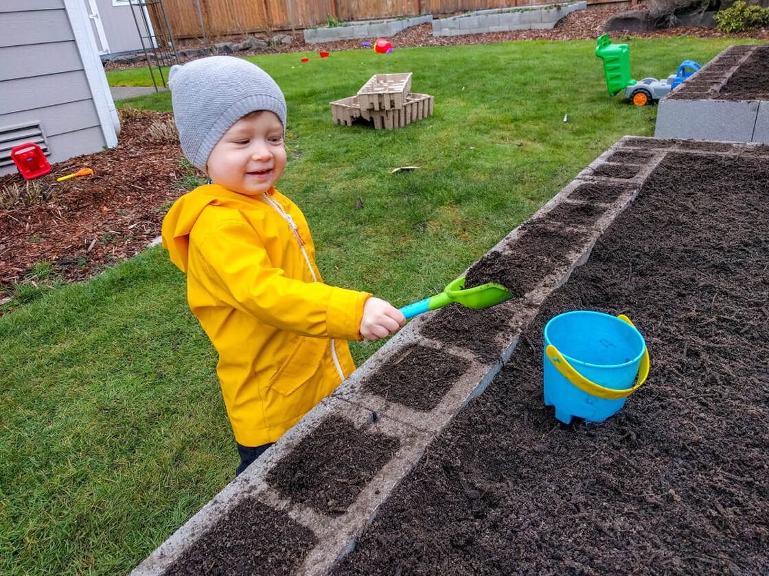 My son doing a quality check on the garden bed soil